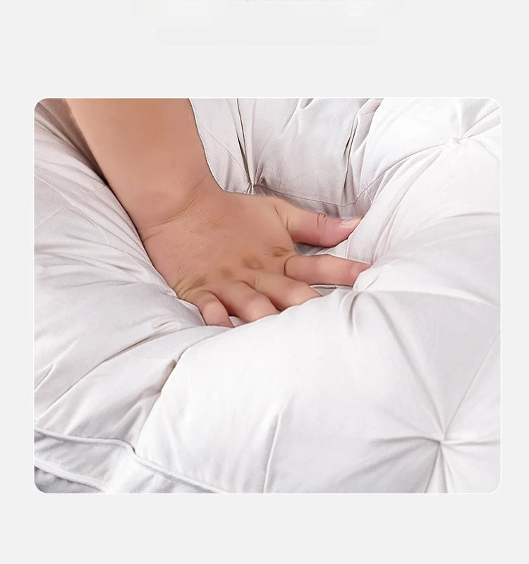Hand pressing into a soft white Goose Pillow showcasing the plush and comfortable design of the down fill.